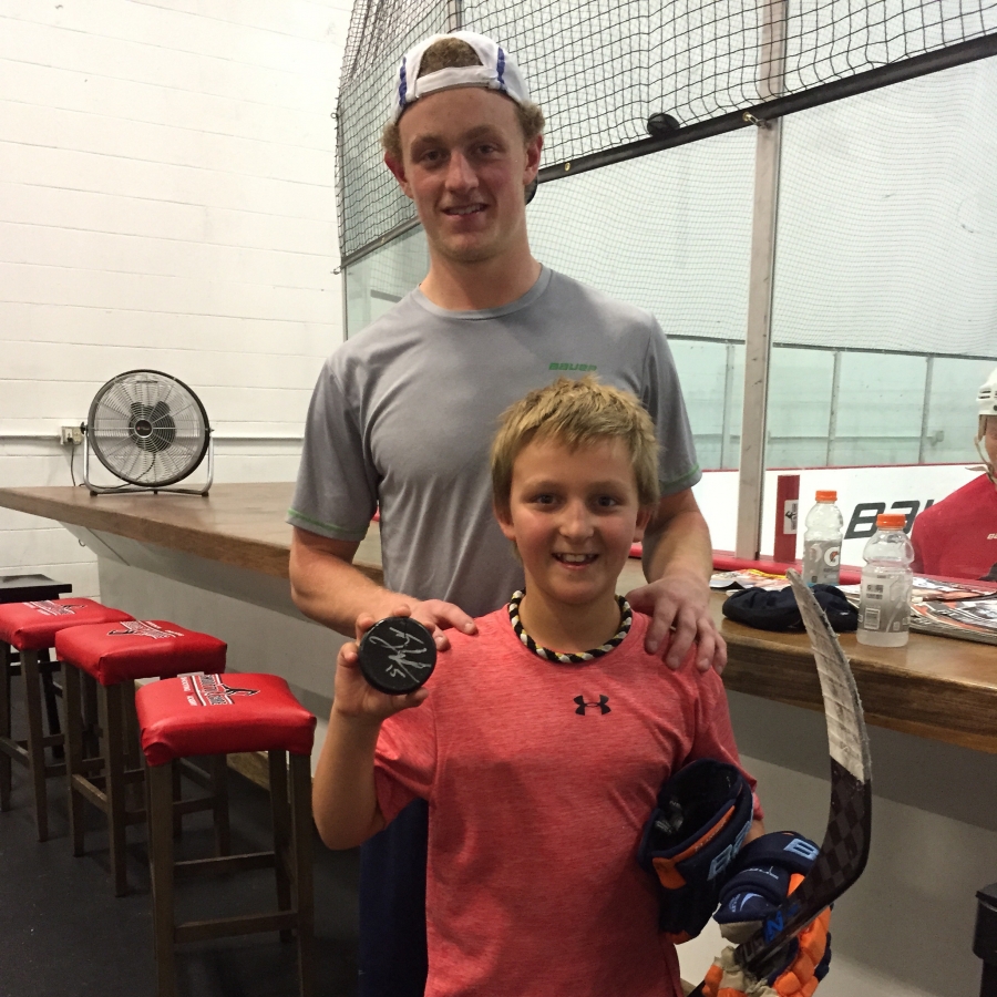 Jack Eichel and Lucas with Jack's signed broken puck